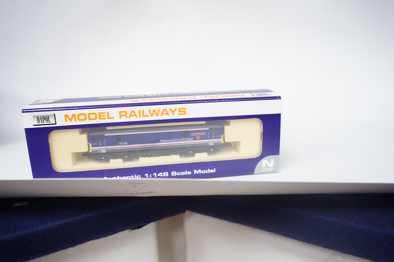 Three boxed Dapol N gauge railway Class 73 electro-diesel locomotives; 73119 Kentish Mercury (ND-022a), 73129 City of Winchester (ND-012a) and 73133 (ND-021b). Condition - good.